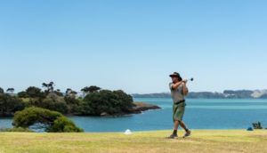 A golfer taking a swing at Waitangi Gold Course