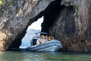 Tour boat exploring sea caves along the Coromandel coast near Whitianga