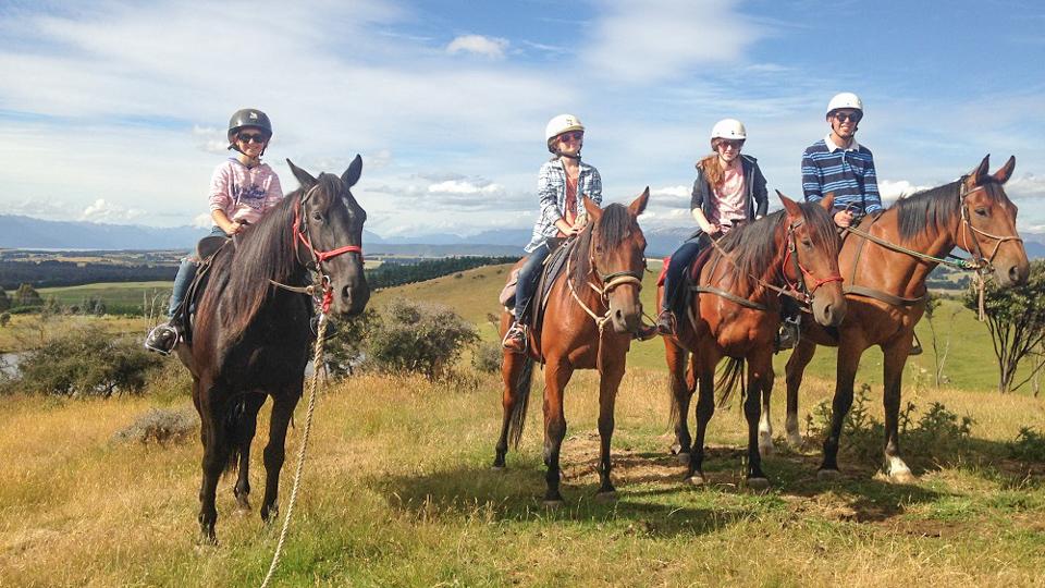 Young girls on horse back in fiordland