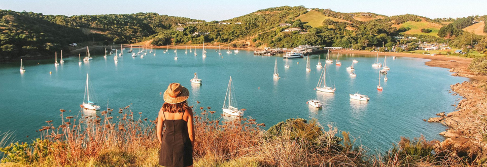 Young girl walking the scenic trails on Waiheke Island. View towards the wharf