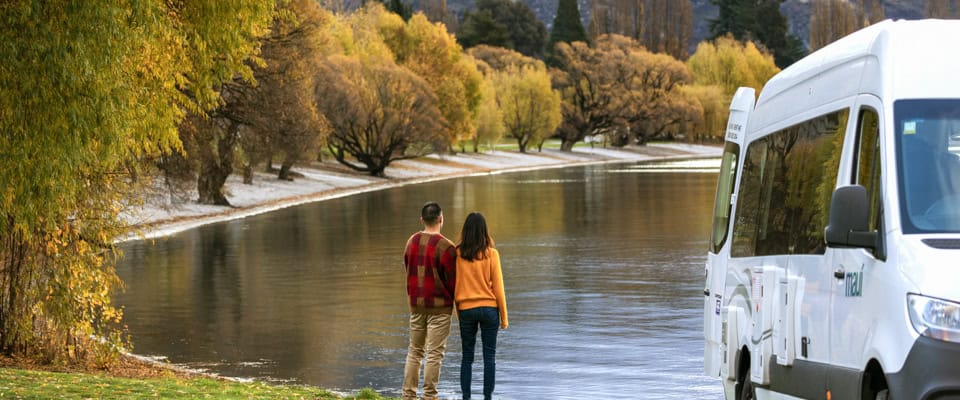 Young couple oat Wanaka Lakefront, Campervan in foreground