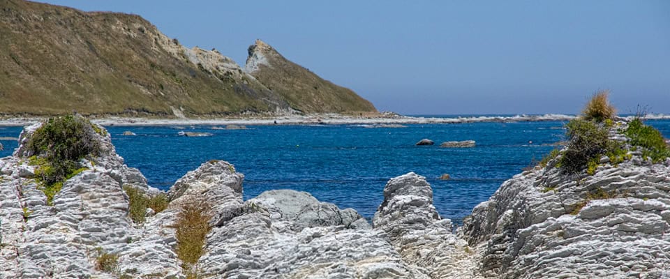 South Bay coastal path with limestone shelves and turquoise water
