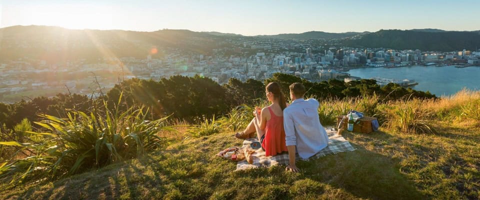 Young Couple having Picnic at Mount Victoria overlooking wellington Cityscape